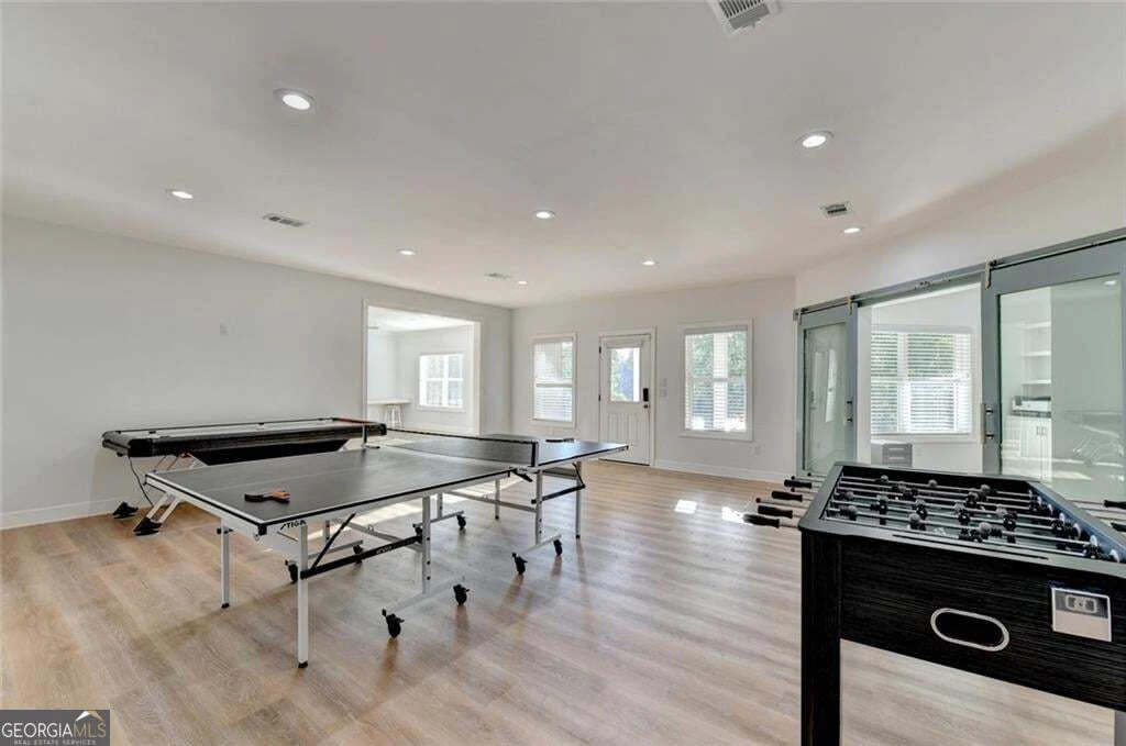 Game room pictured with table tennis and foosball